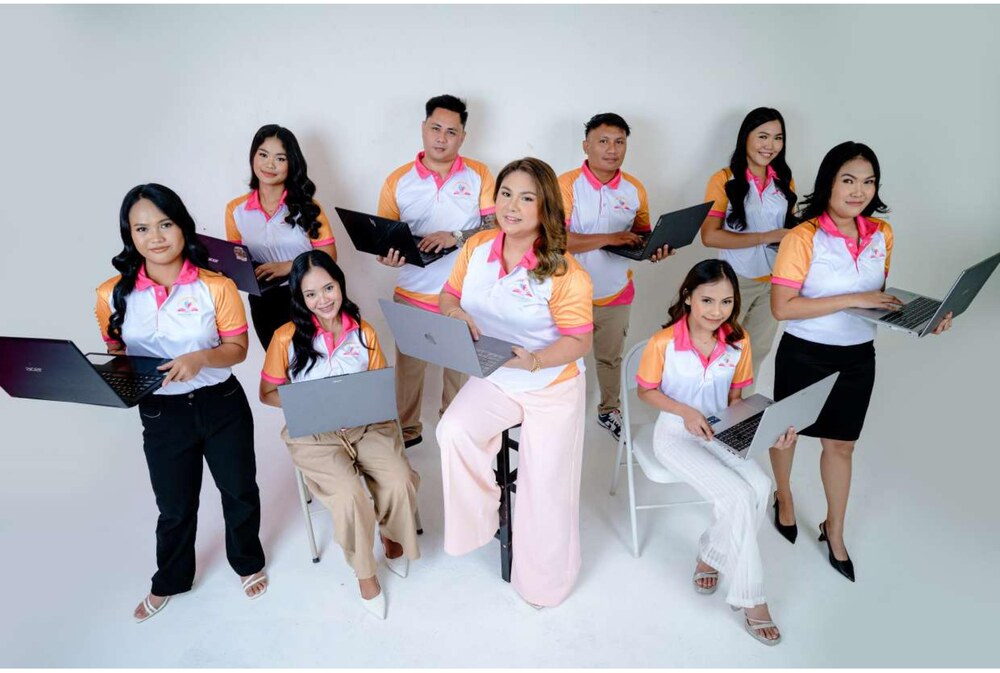 The Childcare VA's team, laptops in hand and ready to work
