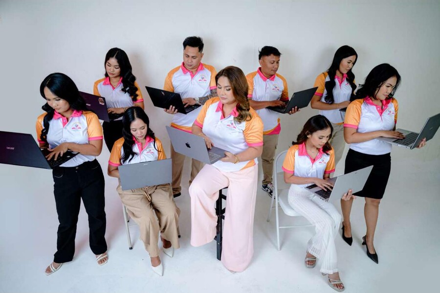 The Childcare VA's team with laptops, ready to work